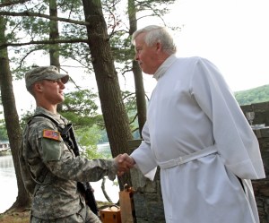 MILITARY CHAPLAIN GREETS CADET BEFORE CELEBRATING MASS AT CAMP BUCKNER IN WEST POINT, N.Y.